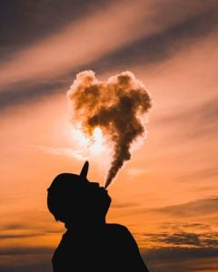 Man exhaling big CBD vape cloud